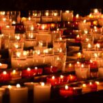 Memorial candles glowing in remembrance at a vigil