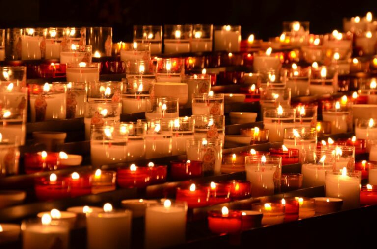 Memorial candles glowing in remembrance at a vigil
