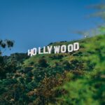Hollywood sign on hillside in Los Angeles against blue sky