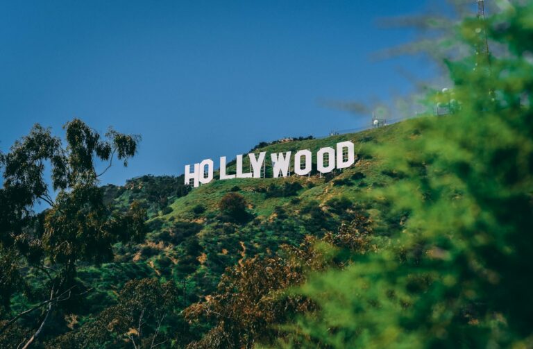 Hollywood sign on hillside in Los Angeles against blue sky