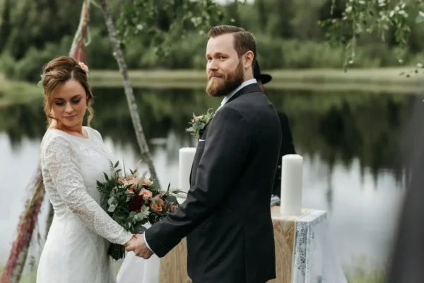 woman and man wedding standing by a lake