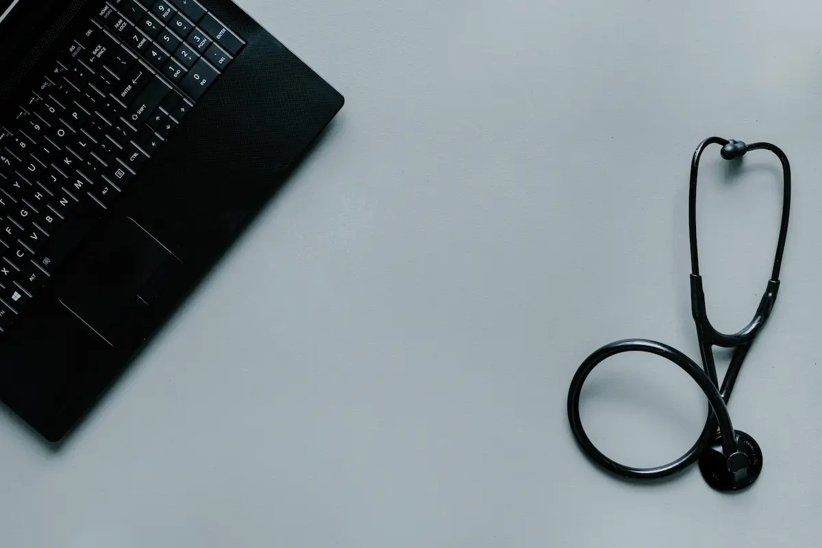 Stethoscope and tablet on white background